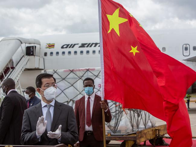 A Chinese envoy to Zimbabwe claps after the arrival of the of Sinovac and Sinopharm vaccines at Harare International Airport last week. Picture: Getty Images