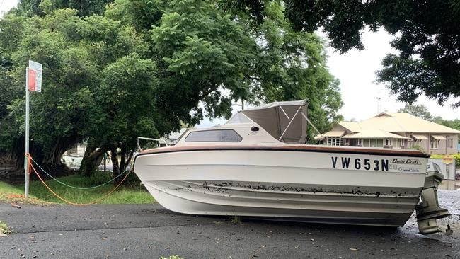 A boat was left stricken on Laurel Avenue as flood water receded on Tuesday.