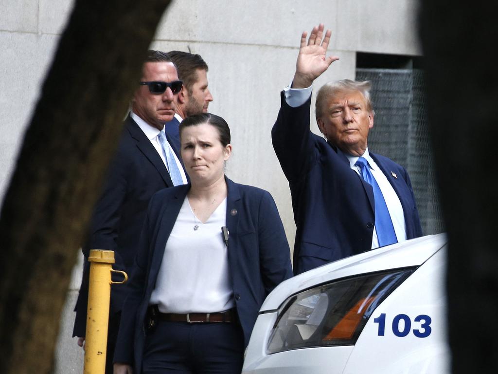 Donald Trump waves to supporters while leaving court. Picture: AFP