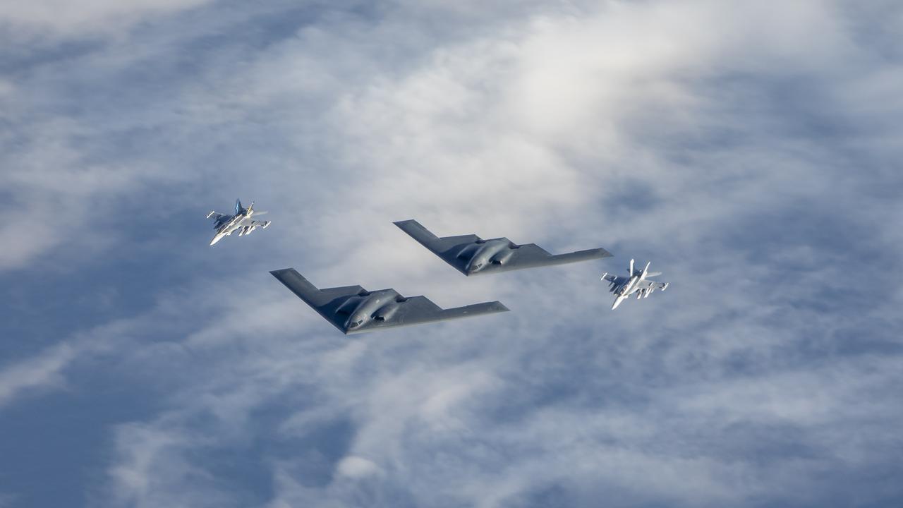 Two Royal Australian Air Force EA-18G Growler jets fly in formation with two United States air force B-2 Bomber aircraft. Picture: FSGT Christopher Dickson