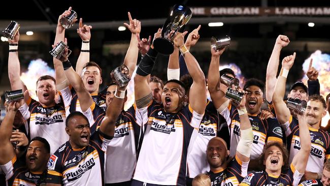 The Brumbies celebrate their grand final win during the trophy presentation post match. Picture: Getty Images