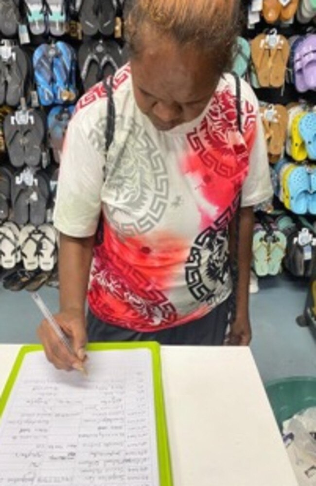 A customer of Urban Rampage Tennant Creek signing a petition to bring back Centrepay at the store. Picture: Facebook