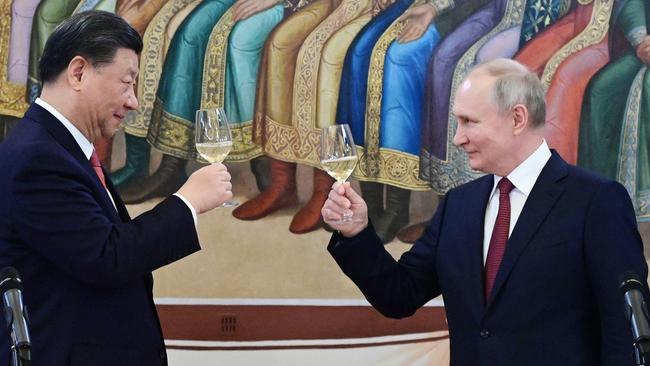 Vladimir Putin and Xi Jinping make a toast during a reception following their talks at the Kremlin. Picture: AFP.