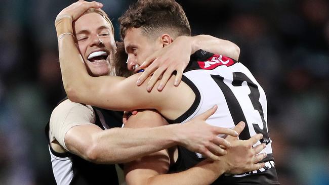 ADELAIDE, AUSTRALIA - AUGUST 27: Orazio Fantasia of the Power celebrates a goal his Ollie Wines, Miles Bergman during the 2021 AFL Second Qualifying Final match between the Port Adelaide Power and the Geelong Cats at Adelaide Oval on August 27, 2021 in Adelaide, Australia. (Photo by Sarah Reed/AFL Photos via Getty Images)