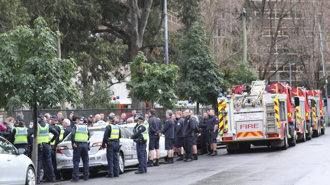 Emergency services work to deliver much-needed supplies to locked-down North Melbourne residents. Picture: David Crosling