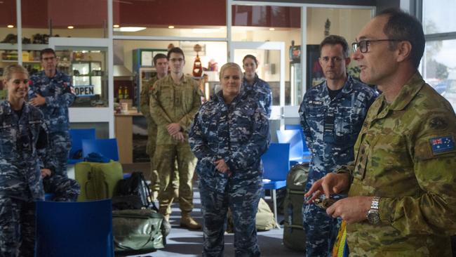 Commander Task Group 629.5, Colonel David Hughes, (right) addresses Australian Defence Force personnel and members of the Australian Medical Assistance Team at Burnie Airport before they leave Tasmania following their support to Burnie’s North West Regional Hospital. .