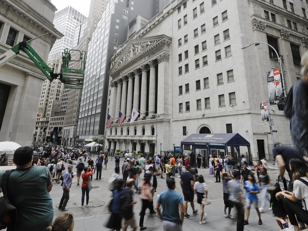 Pedestrians pass the New York Stock Exchange in New York. The US stock market opened down again for the third day. Picture: AP Photo/Frank Franklin II