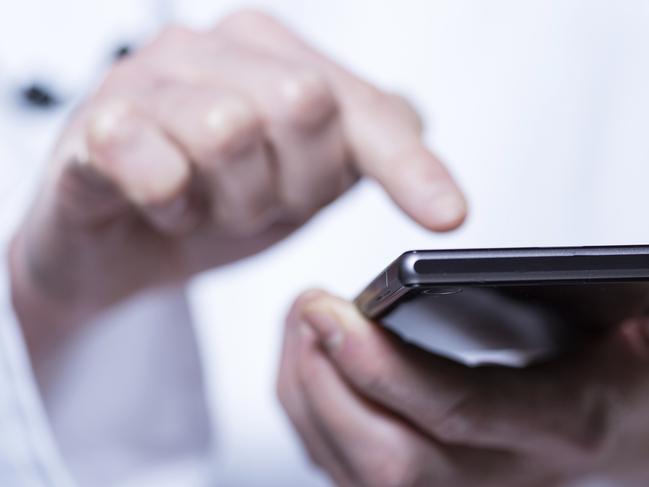 Close-up of hands of doctor using phone in hospital Photo: iStock