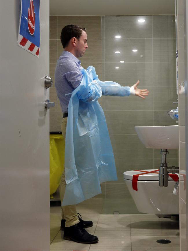 Bradley McEntee puts on his PPE before work. Picture: Sam Ruttyn