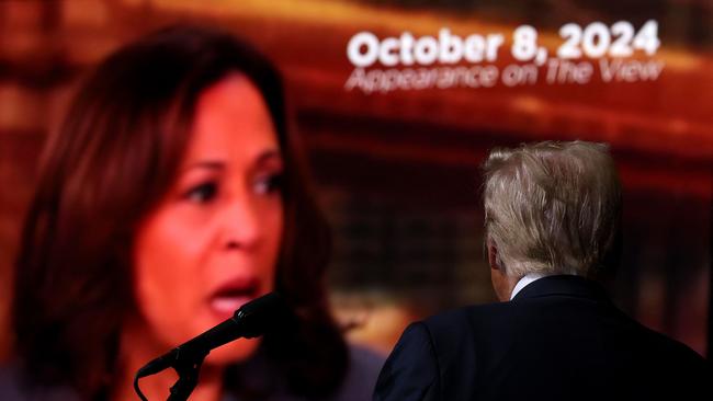 Republican presidential nominee, former US President Donald Trump, watches a video featuring U.S. Vice President Kamala Harris during a campaign rally at the Grand Sierra Resort on October 11, 2024 in Reno, Nevada. Picture: Getty