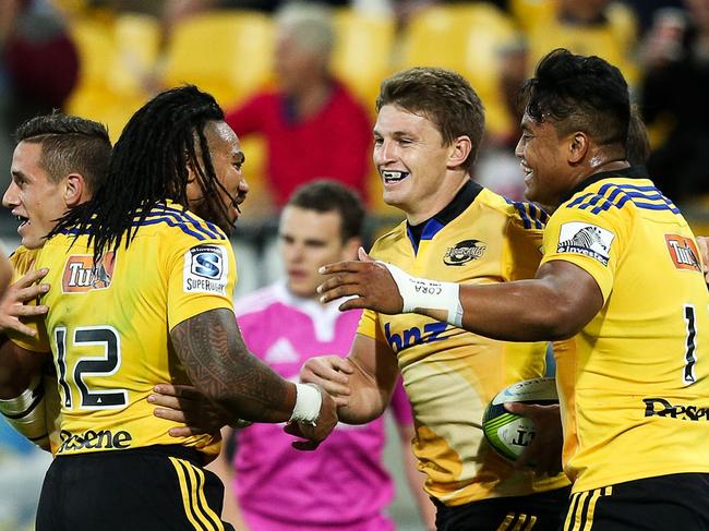 WELLINGTON, NEW ZEALAND - APRIL 03: Ma'a Nonu, Beauden Barrett and Julian Savea of the Hurricanes celebrate Barrett's try during the round eight Super Rugby match between the Hurricanes and the Stormers at Westpac Stadium Stadium on April 3, 2015 in Wellington, New Zealand. (Photo by Hagen Hopkins/Getty Images)