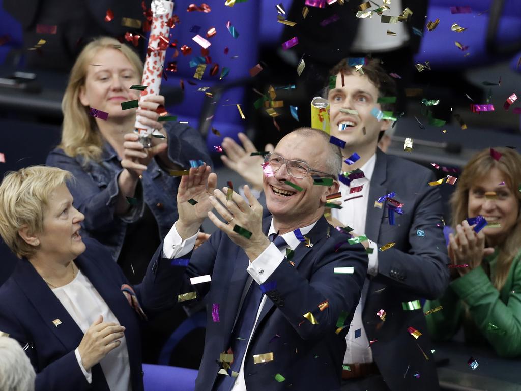 Green Party's gay rights activist Volker Beck, front right, and fellow faction members celebrate with a confetti popper after German federal Parliament voted to legalise same-sex marriage in Berlin. Picture: Michael Sohn