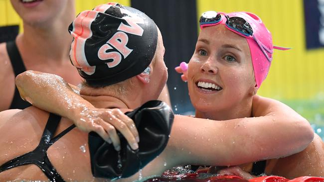 Emma McKeon (right) hugs Ariarne Titmus after winning the 200m freestyle final. Picture: AAP