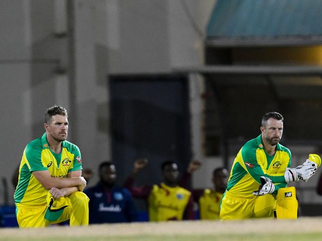 Aaron Finch (L) and Matthew Wade (R) of Australia kneel for Black Lives Matter during the 2nd T20I between Australia and West Indies at Darren Sammy Cricket Ground, Gros Islet, Saint Lucia, on July 10, 2021. (Photo by Randy Brooks / AFP)