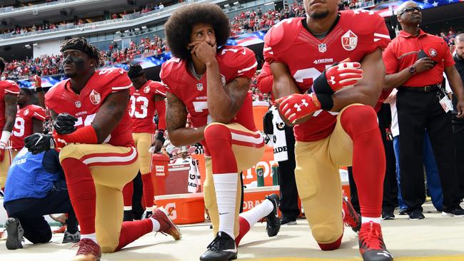 Colin Kaepernick, centre, during a pre-game protest in 2016. Picture: AFP