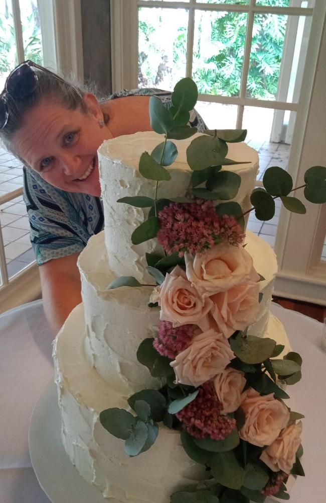 Simone Weatherstone with a decorated wedding cake she made.