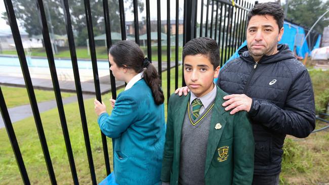 Peter Boutros and his son John with a Catherine McAuley student at the swimming pool near the Morley Centre, which are not part of the diocese’s overhaul. Picture: John Fotiadis