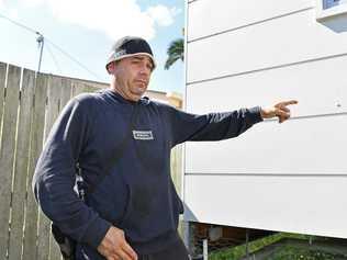 Nambour's Michael Eugene shows where his neighbour's unit was shot up. 