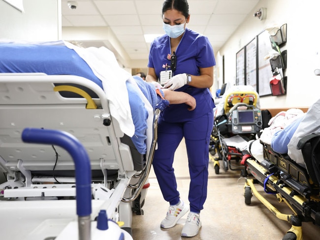 APPLE VALLEY, CALIFORNIA - MARCH 11: (EDITORIAL USE ONLY)  Lab technician Alejandra Sanchez cares for a patient in the Emergency Department at Providence St. Mary Medical Center on March 11, 2022 in Apple Valley, California. The hospital was treating 125 confirmed COVID-19 patients at the peak of the Omicron surge but has seen a sharp decline and is currently caring for 13 confirmed coronavirus patients. Today marks the two-year anniversary of the World Health Organizationâs official declaration of the COVID-19 pandemic. (Photo by Mario Tama/Getty Images)