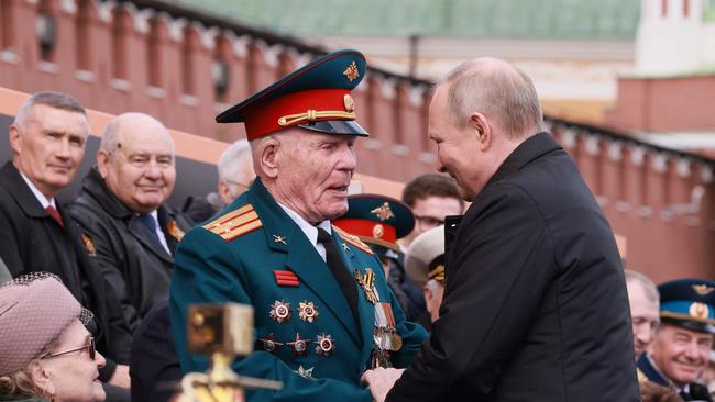 Russian President Vladimir Putin greets veterans as he arrives to watch the Victory Day military parade at Red Square. Picture: Mikhail Metzel/Sputnik/ AFP