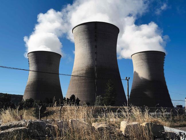 (FILES) Steam rises from the cooling towers of the Bugey nuclear power plant in Saint-Vulbas, central France, on July 20,2023. There will be new debates on nuclear safety reform on March 11, 2024 in the National Assembly, where the government will try to restore a key article of its controversial merger project between , Nuclear Safety Authority (ASN) and IRSN, the Institute of Radiation Protection and Nuclear Safety. (Photo by OLIVIER CHASSIGNOLE / AFP)