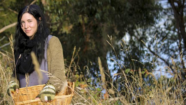 Self-taught herbalist Shy Scott collects a basket of plants to turn into herbal-infused soaps, serums and balms she sells in her home business Twig and Clove. Picture: TRACY RENKIN