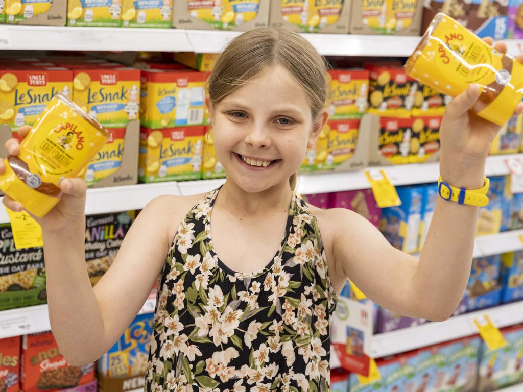 Coles has dropped and locked the price of more that 300 essential products. Amelia LaBan holds Capilano honey at Coles Alderley. NCA NewsWire / Sarah Marshall