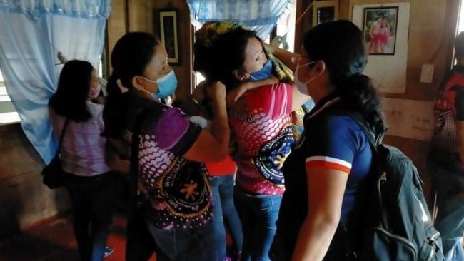 Philippine police remove a victim of sexual abuse from a home in the eastern part of the country after the investigation into Schapel. Picture: AFP.