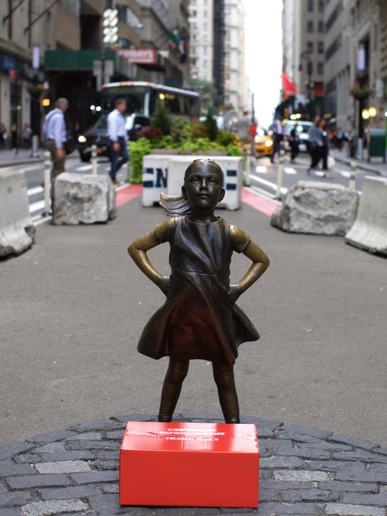 Wall Street stockbrokers and others walked past the statue of the Fearless Girl outside the New York Stock Exchange building in September 2018, unaware the box marked “Copyright Infringement” contained an artwork by Cj Hendry. Picture: supplied