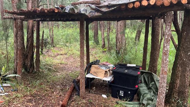 Images of a makeshift bush hut discovered by Australian Defence Force members in Mount Baldy Forest Reserve, which police allege contained weapons, food, and child exploitation material. A 48-year-old Kanimbla man has been arrested and charged with two counts of possess child exploitation material and one count of unlawful possession of weapons category E.