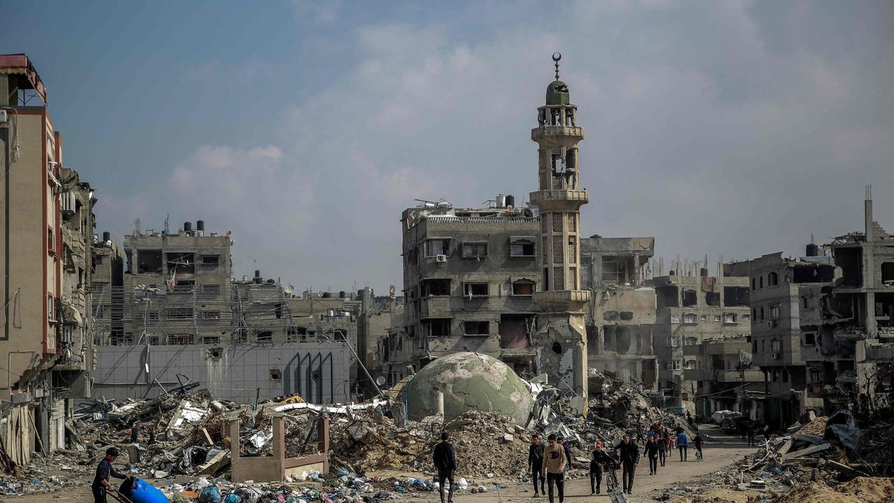 TOPSHOT - Palestinians walk amid debris of a mosque and buildings destroyed during Israeli strikes in Gaza City, on February 26, 2024, amid continuing battles between Israel and the Palestinian militant group Hamas. (Photo by AFP)