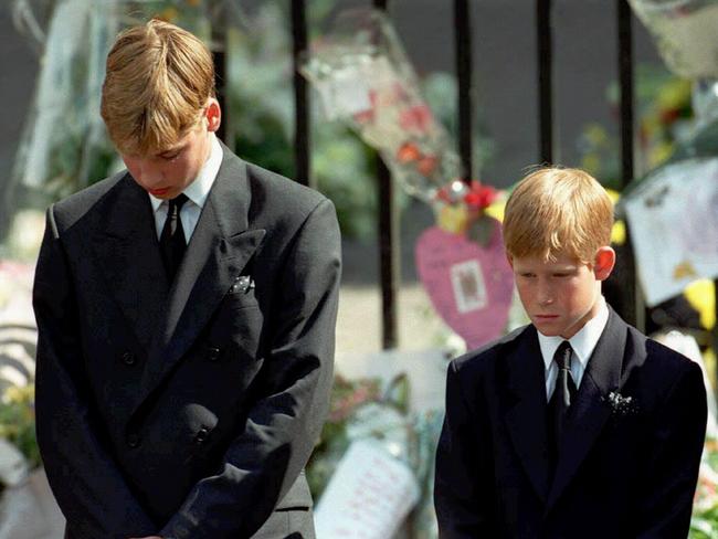 Prince William (15), left, and Prince Harry (12), the sons of Diana, Princess of Wales, bow their heads as their mother's coffin is taken out of Westminster Abbey. Picture: AP