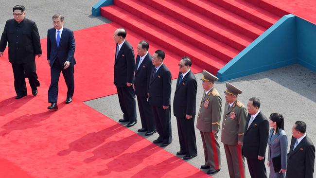 The two leaders walk down a red carpet past representatives from the North to the official summit Peace House building at Panmunjom. Picture: AFP/Korea Summit Press Pool