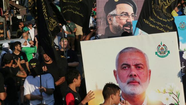 A march by Lebanese youth in the southern city of Saida to protest against the assassination of Hamas chief Ismail Haniyeh (portrait bottom) and Hezbollah military commander Fuad Shukur (top). Picture: AFP