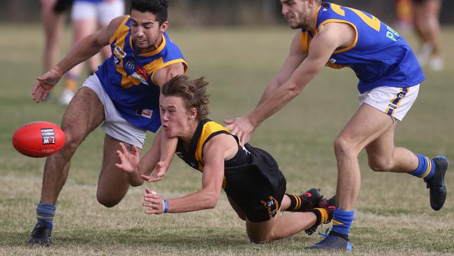 Woori Yallock’s Jack Matthews gets a handball away against Cranbourne on Saturday. Picture: Stuart Milligan