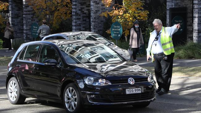 A parking officer near the Sydney Olympic Park Vaccination Centre. Image: John Grainger