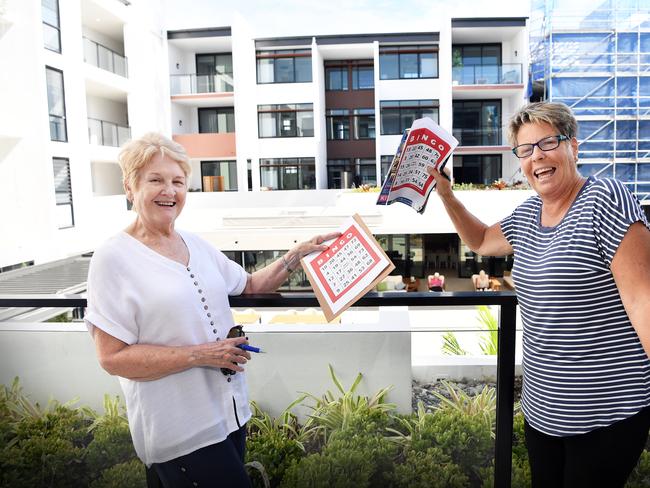 Residents of the Sunshine Coast retirement community are in self isolation but are being well supported in their independent living apartments. The villages community facilities are closed but activities, taking into consideration social distancing, include Balcony Bingo where residents step outside their front door to take part in some fun. Pictured, Elaine Marsh and Margaret Smith. Photo Patrick Woods / Sunshine Coast Daily.