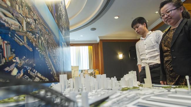 Guests examine a scale model of central Sydney at a property showcase by Lend Lease at the Four Seasons Hotel in 2014. The crackdown on unauthorised capital flows out of China could crimp demand for high-end property in cities around the world.