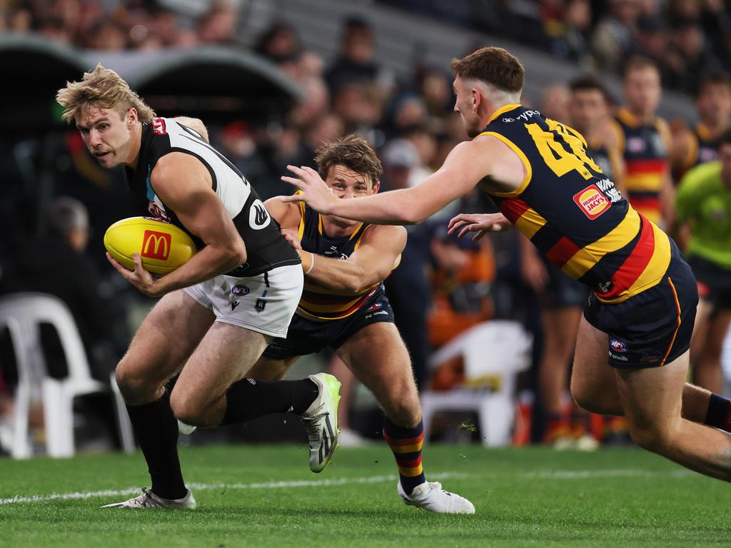 Matt Crouch and Mark Keane go after Port Adelaide star Jason Horne-Francis. Picture: James Elsby/AFL Photos