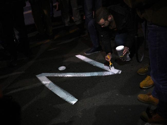 A protester paints the 