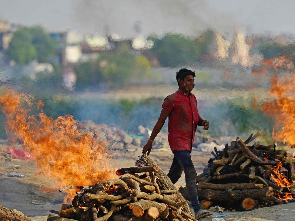 Funeral pyres burn as the last rites are performed of the patients who died of the coronavirus at a cremation ground in Allahabad.