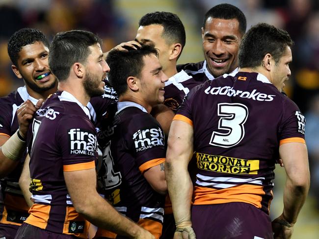 Broncos players celebrate a try by Kodi Nikorima (centre) during the round 20 NRL game between the Brisbane Broncos and the Canterbury-Bankstown Bulldogs at Suncorp Stadium in Brisbane, Thursday, July 20, 2017. (AAP Image/Dan Peled) NO ARCHIVING, EDITORIAL USE ONLY