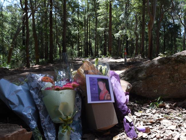 Flowers and tributes left at the site where human remains were found in the Royal National Park. Picture: AAP Image/Dean Lewins