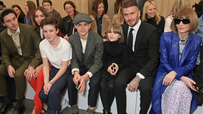 A family affair: Brooklyn Beckham, Hana Cross, Cruz Beckham, Romeo Beckham, Harper Beckham, David Beckham and Dame Anna Wintour attend Victoria’s show during London Fashion Week. Picture: Getty