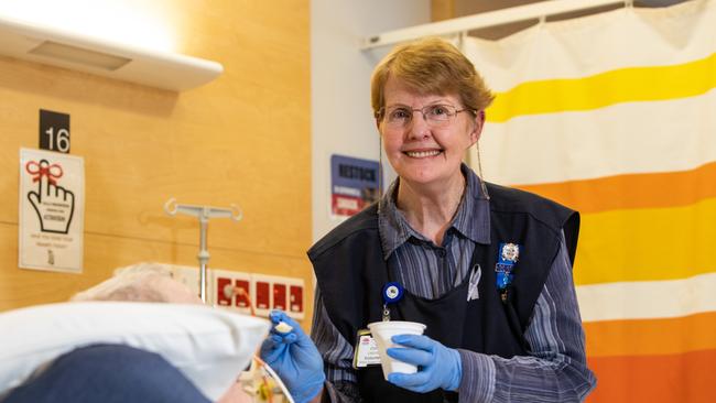 Volunteer feeder Chris Oberle feeding a patient their lunch at Royal North Shore Hospital. Image: Julian Andrews