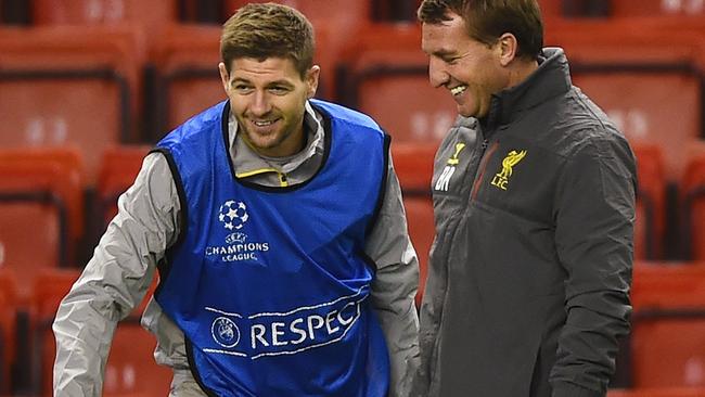 LIVERPOOL, ENGLAND - DECEMBER 08: Brendan Rodgers, manager of Liverpool smiles with Steven Gerrard during a training session ahead of the UEFA Champions League match against FC Basel 1893 at Anfield on December 8, 2014 in Liverpool, England. (Photo by Laurence Griffiths/Getty Images)