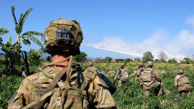 Australian and US soldiers watch a US Army M142 High Mobility Artillery Rocket System (HIMARS) fire in Puslatpur, Indonesia, during Exercise Super Garuda Shield 2023. Photo: Defence