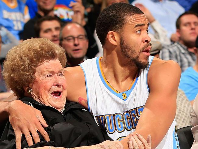 DENVER, CO - NOVEMBER 21: JaVale McGee #34 of the Denver Nuggets protects the fans as he ended up in the front row after saving the ball against the New Orleans Pelicans at Pepsi Center on November 21, 2014 in Denver, Colorado. The Nuggets defeated the Pelicans 117-97. NOTE TO USER: User expressly acknowledges and agrees that, by downloading and or using this photograph, User is consenting to the terms and conditions of the Getty Images License Agreement. Doug Pensinger/Getty Images/AFP == FOR NEWSPAPERS, INTERNET, TELCOS & TELEVISION USE ONLY ==