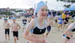 Amy Gooley runs to the starting line. The second day of the Schools Triathlon Challenge at Bellerive Beach.