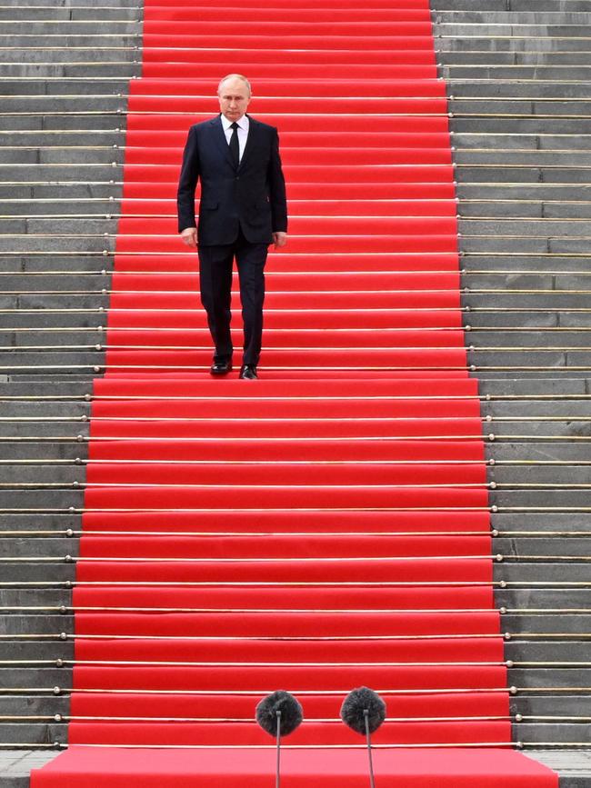 Russian President Vladimir Putin walks down the steps to address troops from the defence ministry, National Guard, FSB security service and interior ministry. Picture: AFP